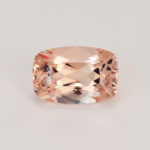 Natural bright reach peech color cushion faceted loose morganite beryl loupe clean single gemstone. Light background.